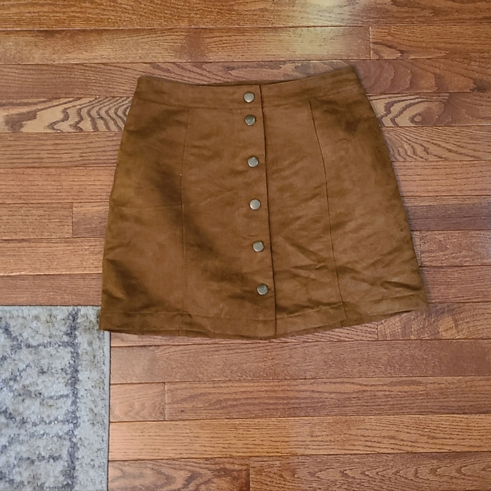 Tan shirt.